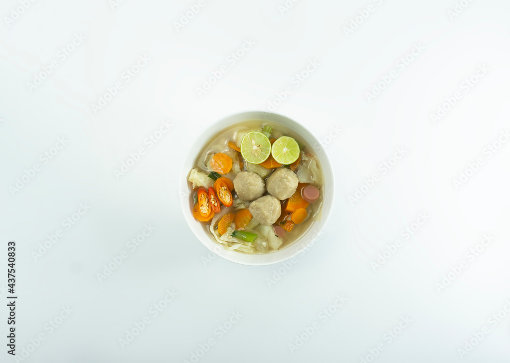 Indonesian Food | Meatball soup served in a white round bowl on a white background Indonesian Food | Meatball soup served in a white round bowl on a white background