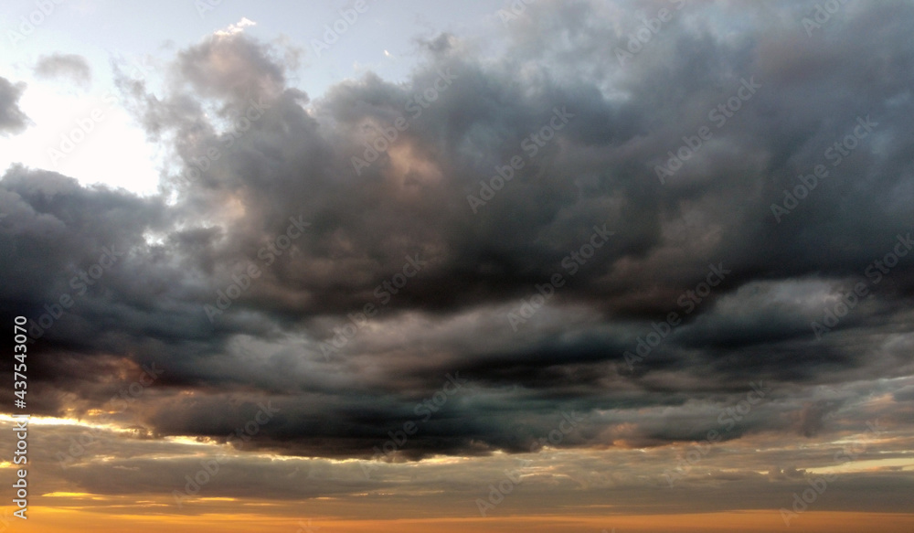 Beautiful contrasting clouds in the sky at sunset. Background for design