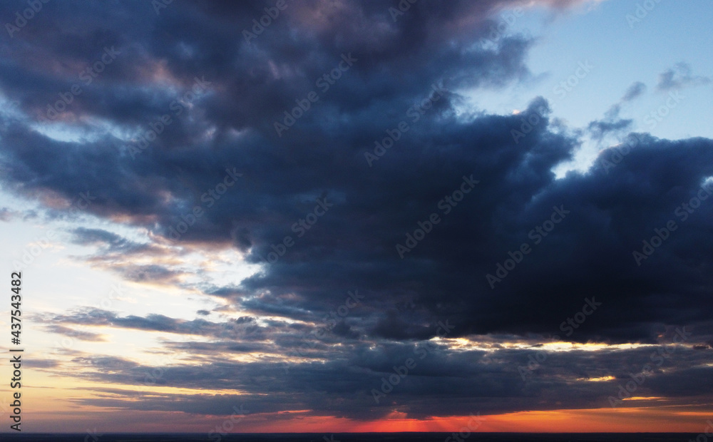 Beautiful contrasting clouds in the sky at sunset. Background for design