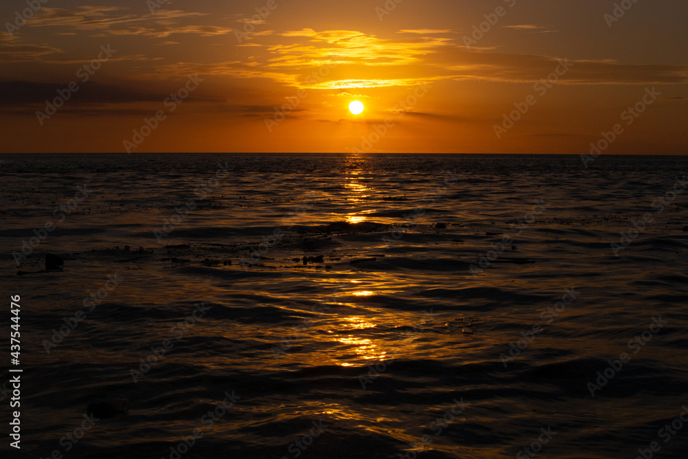 sunset in the middle of the sea