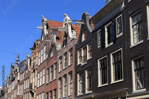 Amsterdam Traditional Historic House Facades with Bell Gables Against a Blue Sky © Monica