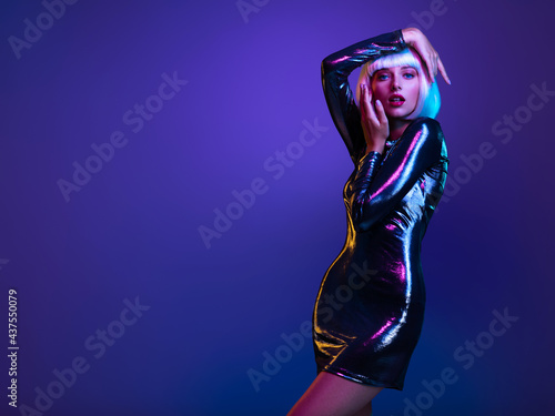 Stylish blonde in shiny dress. Full-length portrait of beautiful  fashionable woman in shining dress, space concept. Art portrait  of  an young attractive model. Fantasy style. Glamour fashion girl