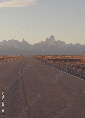 Sunset in the Mountains. El Chalten Road, Patagonia, Argentina. Fiz Roy Mountain on a Evening Sky Background. Los Glacieres National Park. Empty Highway to Andes Mountains. photo