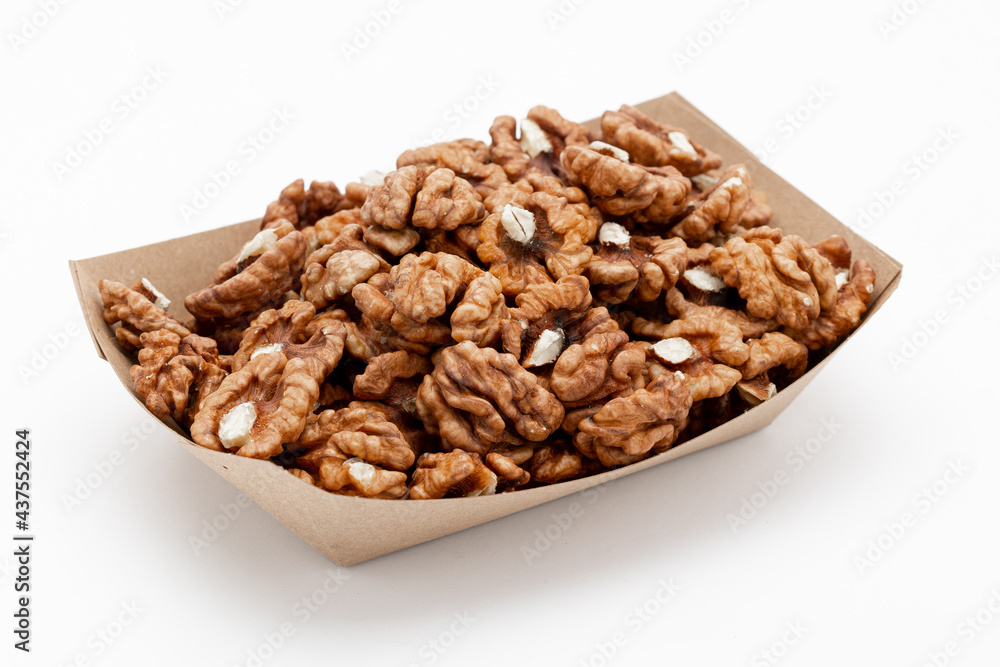 Peeled walnuts in a craft box on white, angled view. Template for designers Peeled walnuts in a craft box on white, angled view. Template for designers