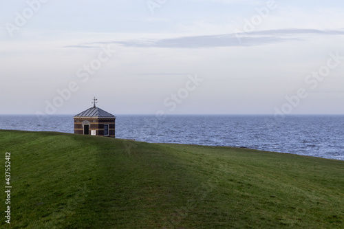 Seahouse near Hindeloopen and the IJsselmeer during a day with clear skies and calm water/seas. Friesland province, the Netherlands photo