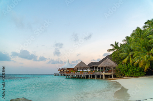 Amazing tropical Maldives island panorama. Beautiful beach and lagoon landscape background during sunrise.  Vacation  holiday and romantic honeymoon banner concept.