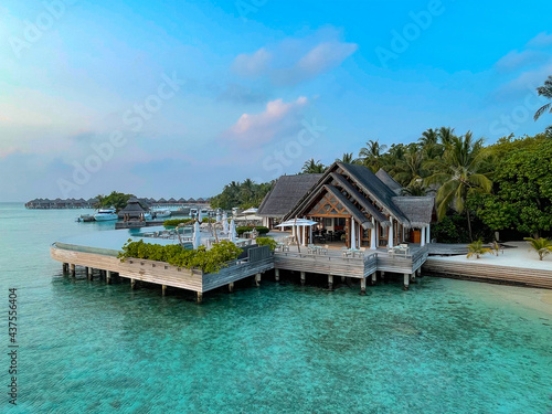 Amazing tropical Maldives island panorama. Beautiful beach and lagoon landscape background during sunrise.  Vacation, holiday and romantic honeymoon banner concept.