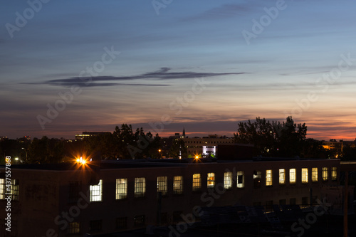 Panoramic view of old industrial building seen at dusk with roofs and church spire in the background, Montreal, Quebec, Canada