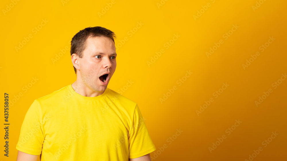 Banner. Young handsome man wearing casual t-shirt over yellow background afraid and shocked with surprise and amazed expression, fear and excited face. Banner. Young handsome man wearing casual t-shirt over yellow background afraid and shocked with surprise and amazed expression, fear and excited face.