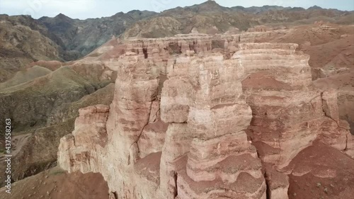 Wallpaper Mural Grand canyon Charyn. Rocks from sedimentary rocks. Huge cracks in the rocks. The ground is red-orange. Top view from a drone. There is a road in the center. Layers of earth in different colors. Torontodigital.ca