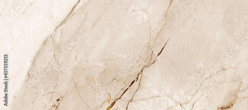 ivory-gold marble stone texture, Intertwined with dark brown streaks, Marble is a hard rock granite and applicability in modern home decor - such as ceramic wall tile exterior-interior, kitchen tile. photo