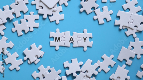 MAY word written on white jigsaw puzzle