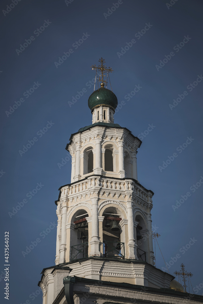 A beautiful tower made of white stone against a blue sky. Colorful architecture. The old tower.