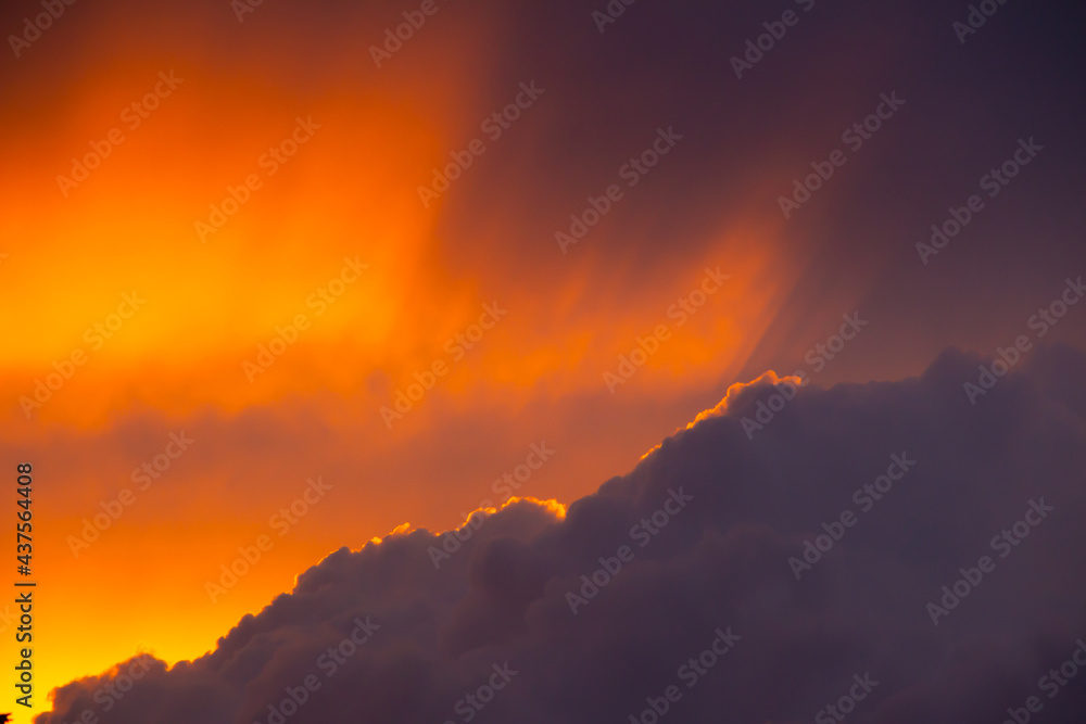Dark storm clouds during sunset with dramatic sky and vibrant colors