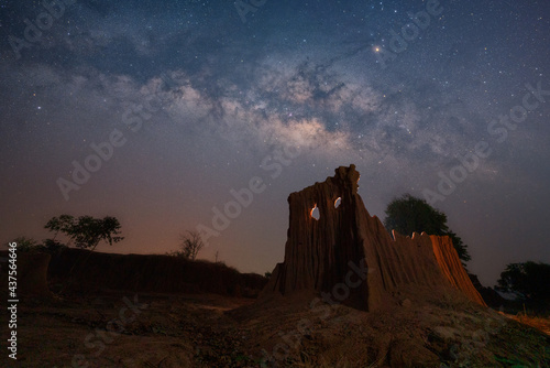  Milky Way with Phi Ta Khon rock. Galaxy, Long exposure Photograph with grain. The milky way and cross above canyon, LaLu in province of Sa kaeo, Thailand photo
