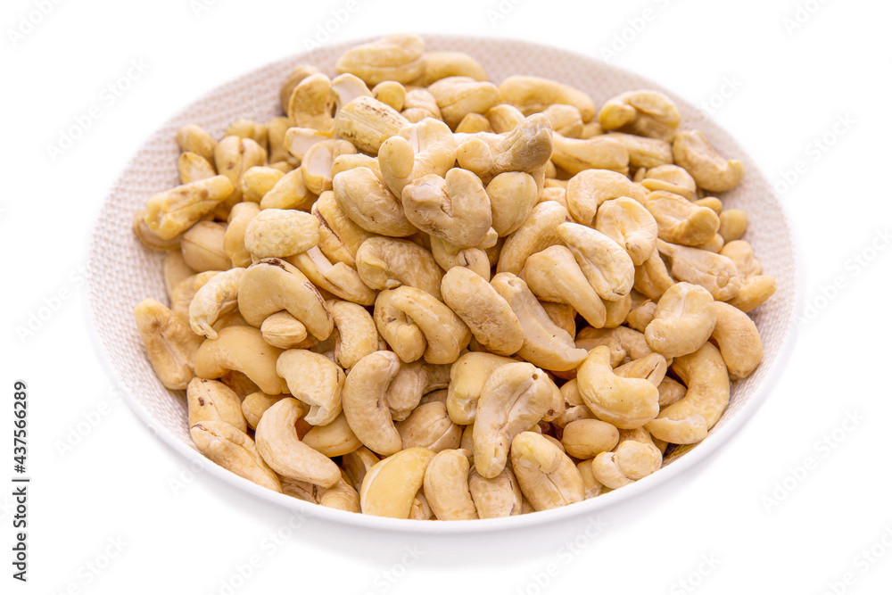 Cashews nuts in a white bowl close-up.isolated food products
