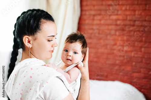 the mother holds the baby after feeding for regurgitation. regurgitation