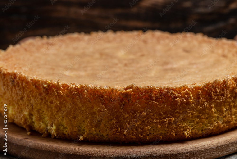 Homemade sponge cake on wooden table, Bakery background concept