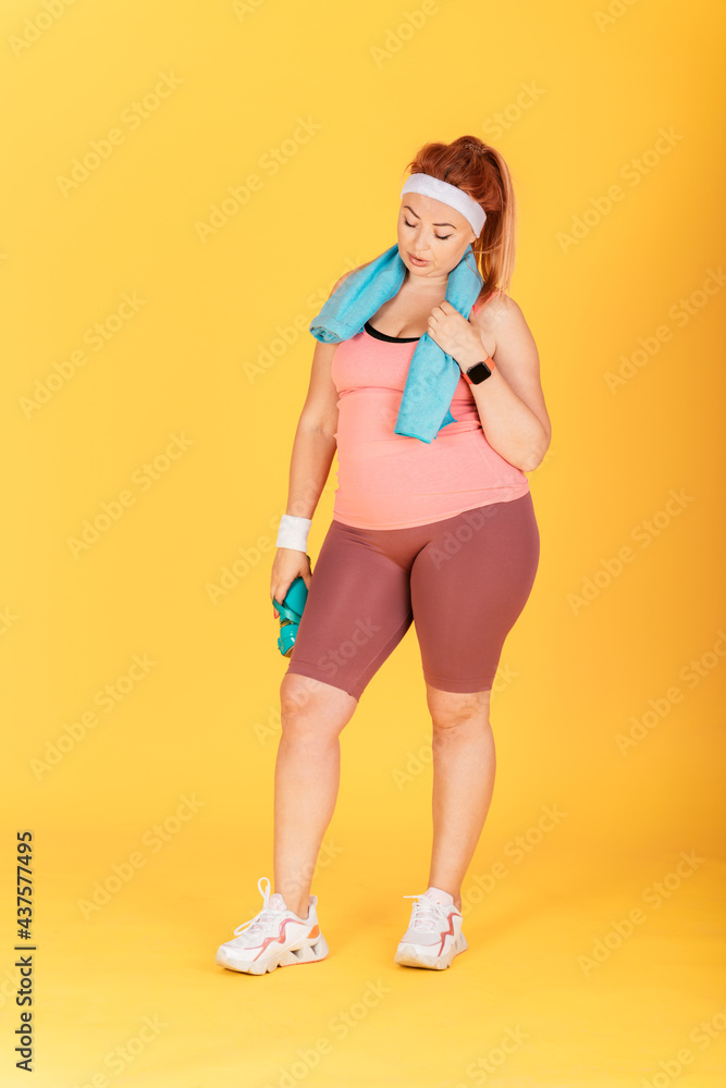 Full length young plus size woman relaxing after workout Full length young plus size woman relaxing after workout