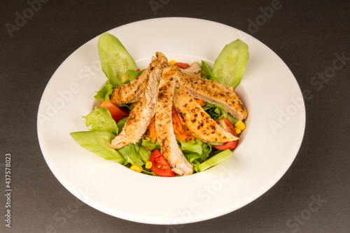 Chicken Saute and Salad light food white 

plate black background
