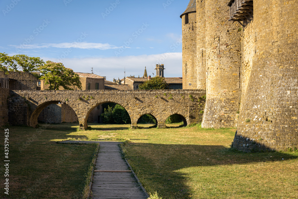 Obraz premium Stone bridge with arches leading to the castle from the medieval fortified citadel of Carcassonne, France