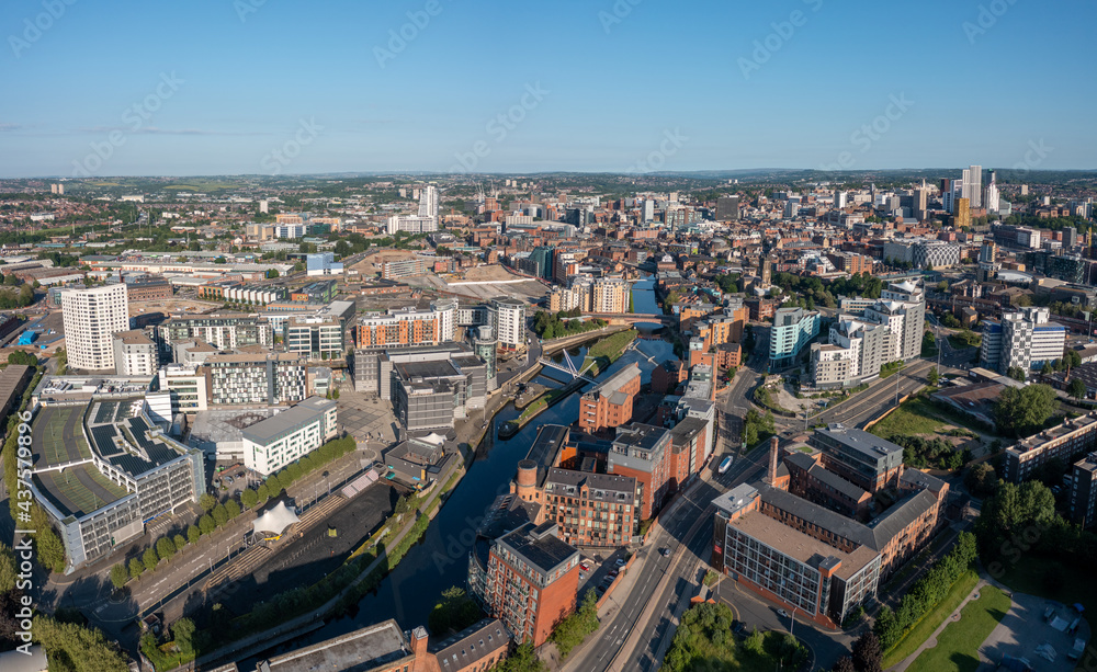 Leeds city centre Yorkshire, England. Aerial view from a drone overlooking the armouries and river towards the retail, offices and apartments on a sunny day. 
