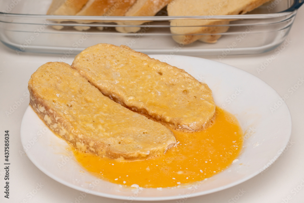 Bread soaked with egg and flour (Torrijas). Typical Spanish Easter sweet. Traditional home cooking concept. Horizontal photography, close-up and selective focus Bread soaked with egg and flour (Torrijas). Typical Spanish Easter sweet. Traditional home cooking concept. Horizontal photography, close-up and selective focus