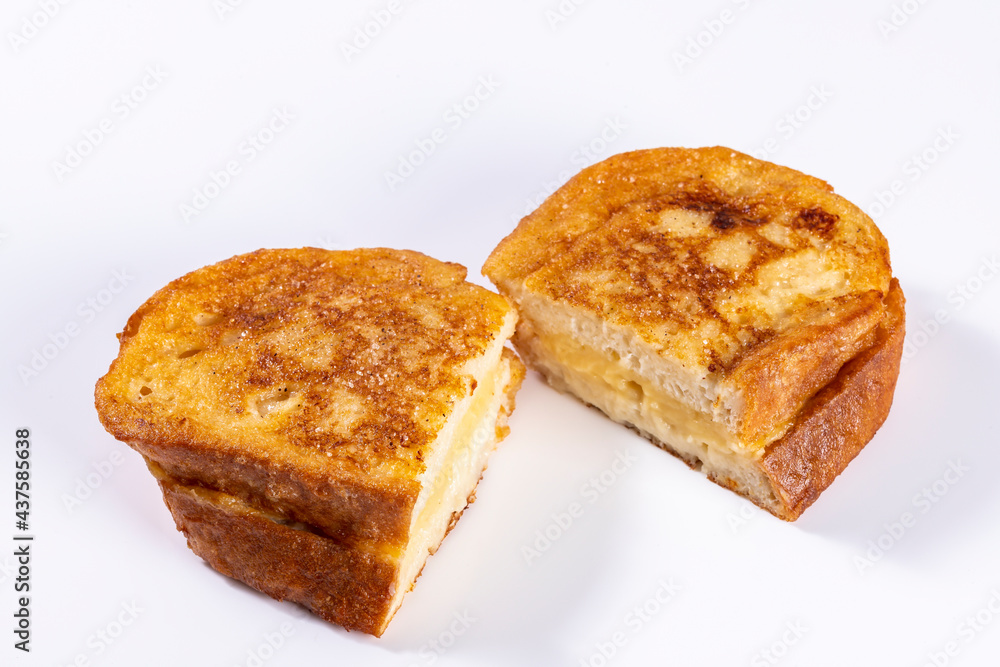 Fried bread with milk, egg, sugar, cinnamon and filled with cream (Torrijas). Typical Spanish Easter sweet. Horizontal photography and selective focus Fried bread with milk, egg, sugar, cinnamon and filled with cream (Torrijas). Typical Spanish Easter sweet. Horizontal photography and selective focus