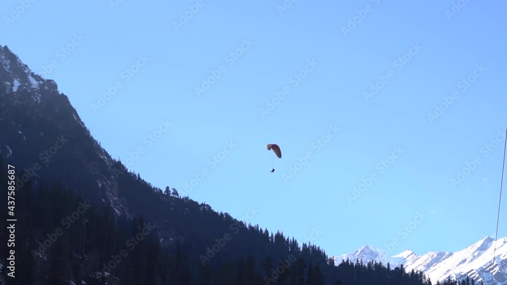 View of the parachute above the snow covered mountain peak at Solang Valley in Manali, Himachal Pradesh, India View of the parachute above the snow covered mountain peak at Solang Valley in Manali, Himachal Pradesh, India