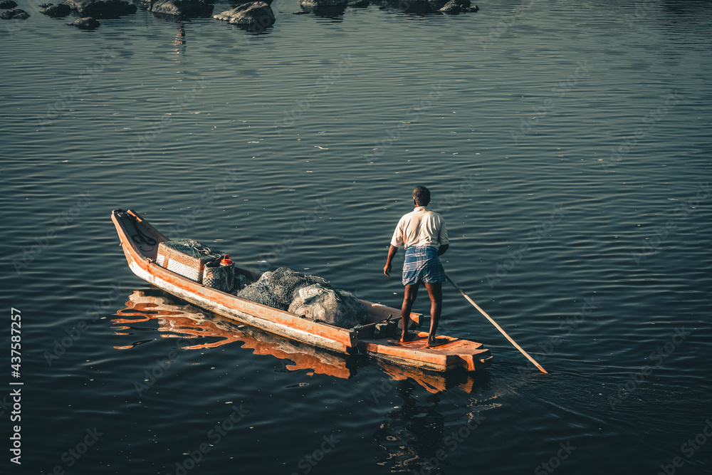 Fishing boats floating on the sea. Fishermans in boat with fishing nets. fishing boat sailing in open waters. man fishing on boat. sailing boat landscape. Peaceful fishing at a lake, near kovalam Fishing boats floating on the sea. Fishermans in boat with fishing nets. fishing boat sailing in open waters. man fishing on boat. sailing boat landscape. Peaceful fishing at a lake, near kovalam