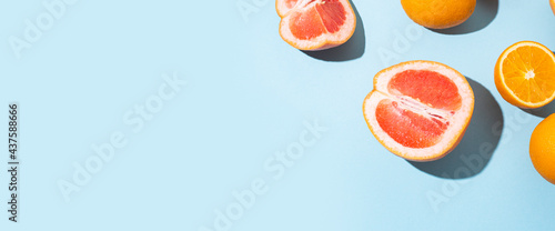 citrus fruits, oranges, grapefruit on a blue background. Top view, flat lay. Banner