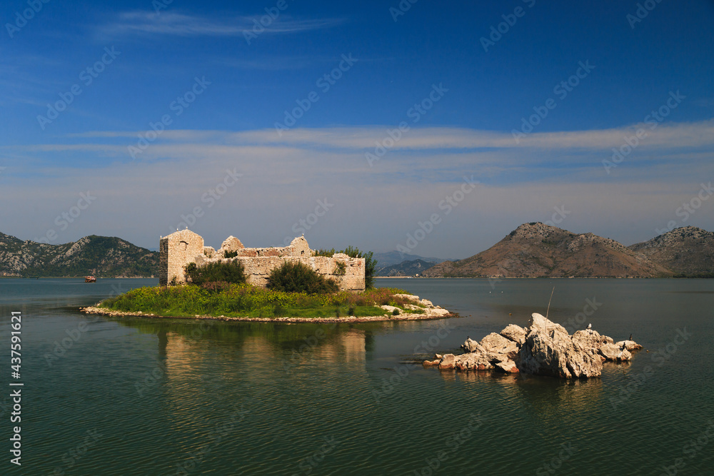A close up view at Grmozur Fortress ruin, former prison at the island Grmozur in Lake Skadar National Park in Montenegro, famous tourist attraction.