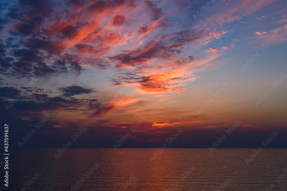 A stunning pink and orange sunset sky in the middle of Mediterranean sea, sunset background.