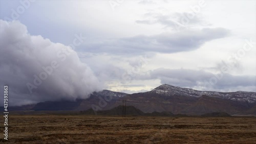 Dramatic storm clouds over mountain peak timelapse