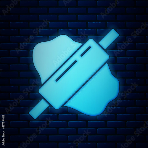 Glowing neon Rolling pin on dough icon isolated on brick wall background. Vector