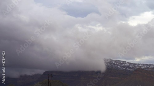Dramatic storm clouds over mountain peak timelapse