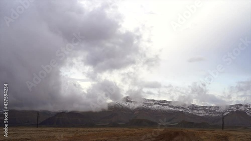 Dramatic storm clouds over mountain peak timelapse