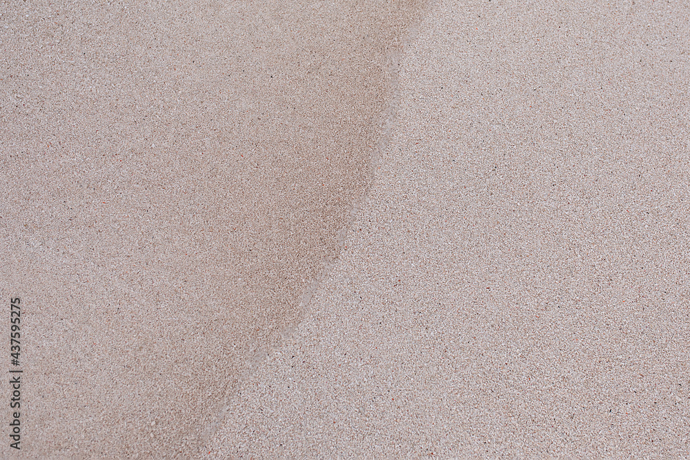 Fototapeta premium the texture of the sand on the beach is wet from the wave. natural background