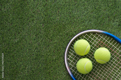 Tennis balls and racket photo
