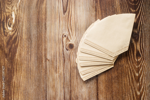 Empty space for text. Paper coffee filters on a brown wood background