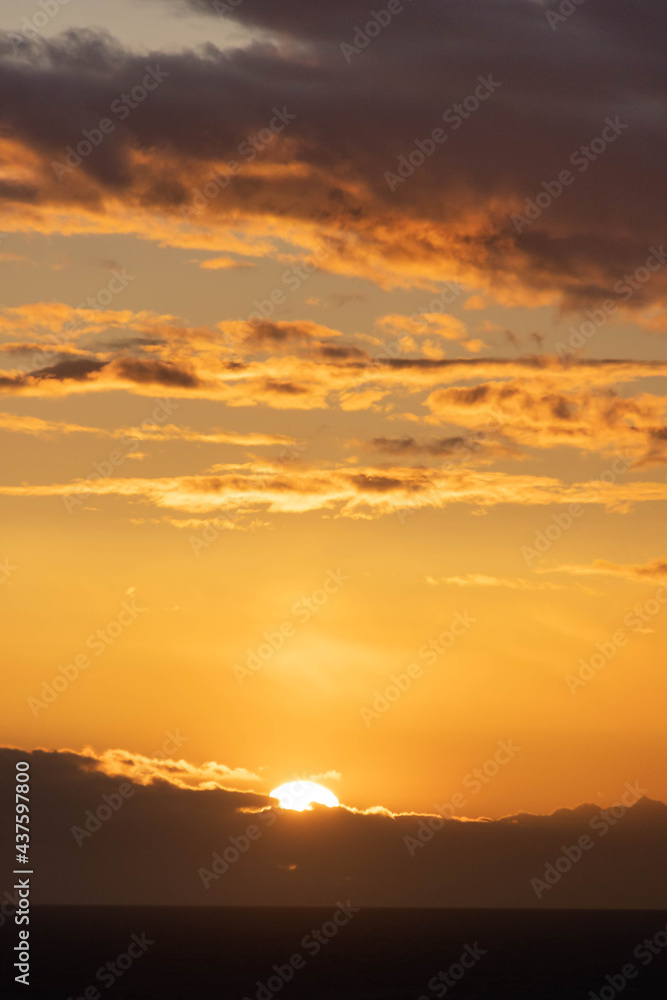 A dramatic sunset over the ocean with colorful skies and color being reflected in the waves below. A dramatic sunset over the ocean with colorful skies and color being reflected in the waves below.