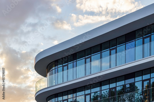 Part of a modern glass building on a background of blue sky.