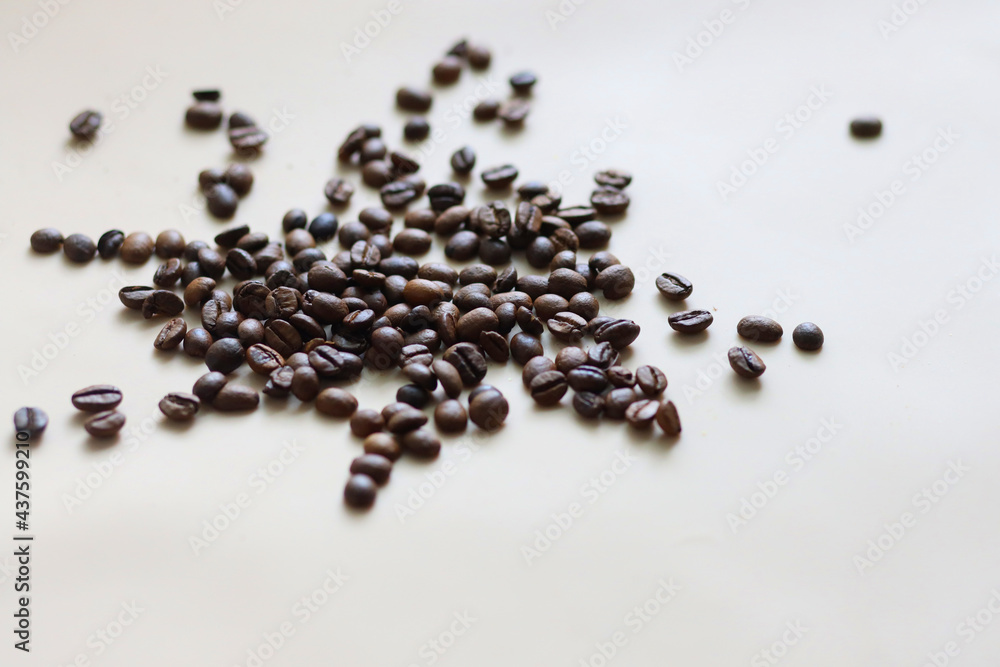 coffee beans scattered in the morning on a white table coffee beans scattered in the morning on a white table