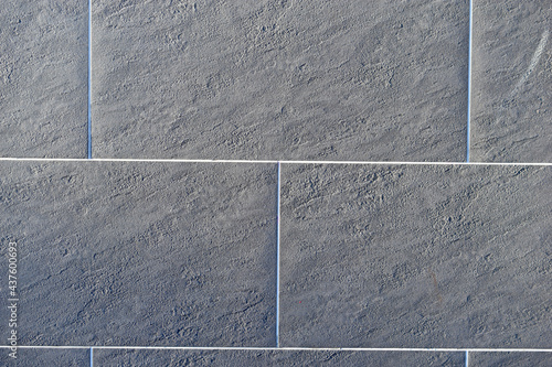 Grey ceramic tiles on the wall of the house