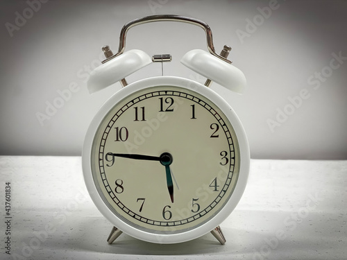 White classic style alarm clock isolated on white background. 