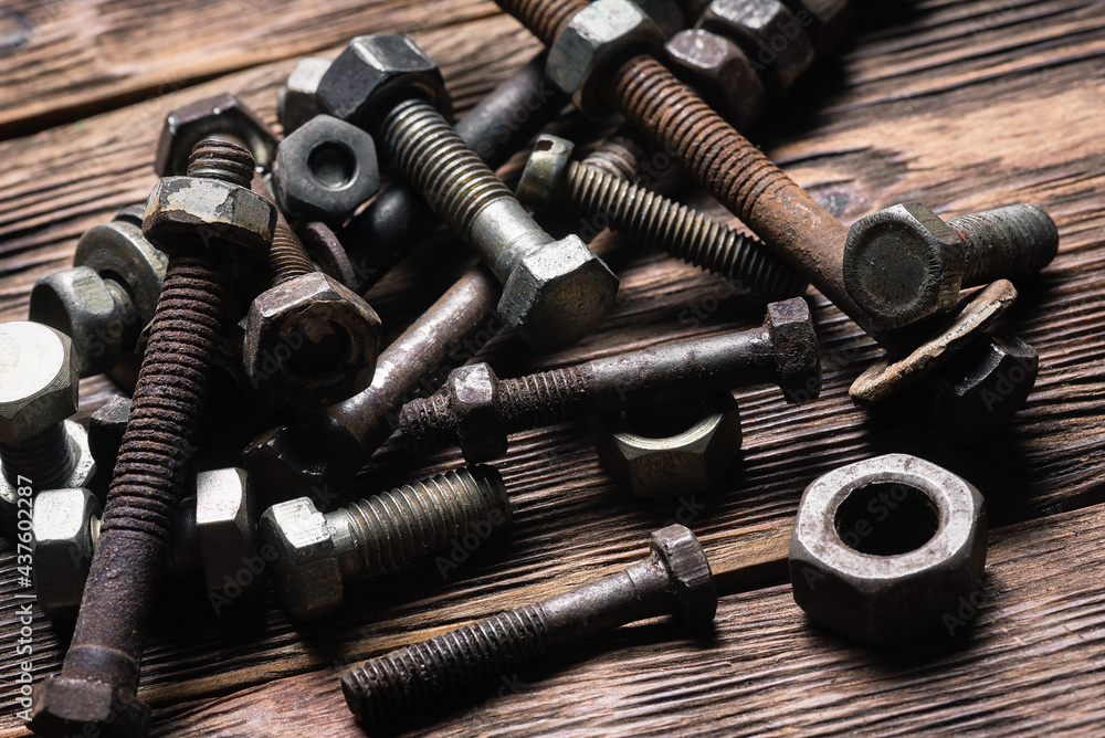 Old rusty bolts and nuts on the carpenter workbench background. Old rusty bolts and nuts on the carpenter workbench background.