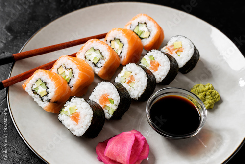 Traditional sushi set - Philadelphia with salmon, cucumber avocado and cream cheese. Japanese cuisine. 