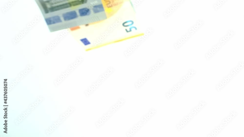 paper banknotes of the european union, euro money falling on the table from above, scattering, slow motion, concept of cash, payments, savings, banking operations paper banknotes of the european union, euro money falling on the table from above, scattering, slow motion, concept of cash, payments, savings, banking operations
