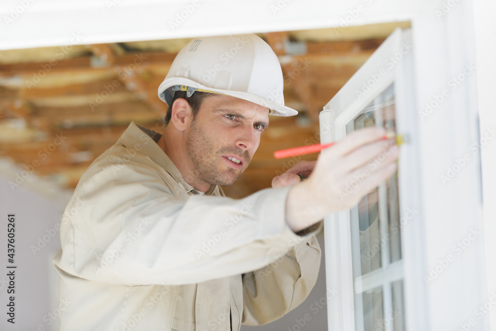 male builder measuring a window male builder measuring a window