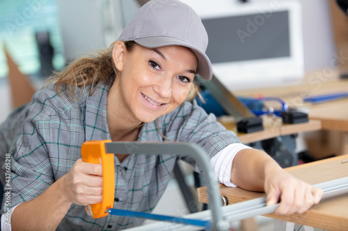 young beautiful woman in overalls preparing for cutting